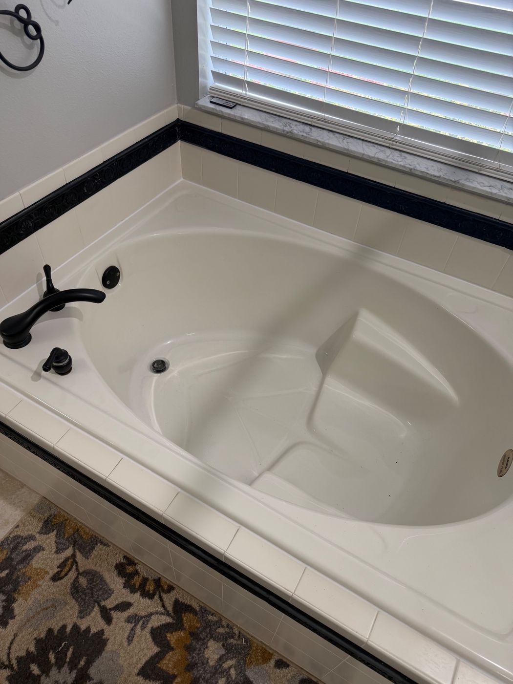 Bathtub with fresh caulk line after recaulking, Groveland FL