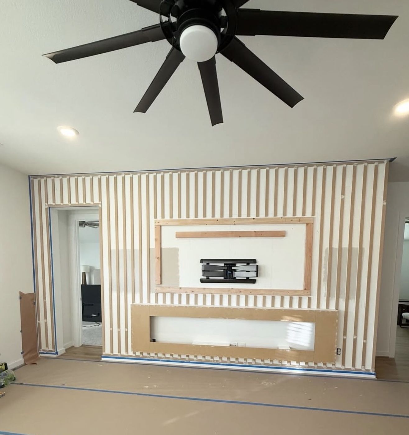 TV accent wall mid-installation, slat panels and framing, Clermont FL